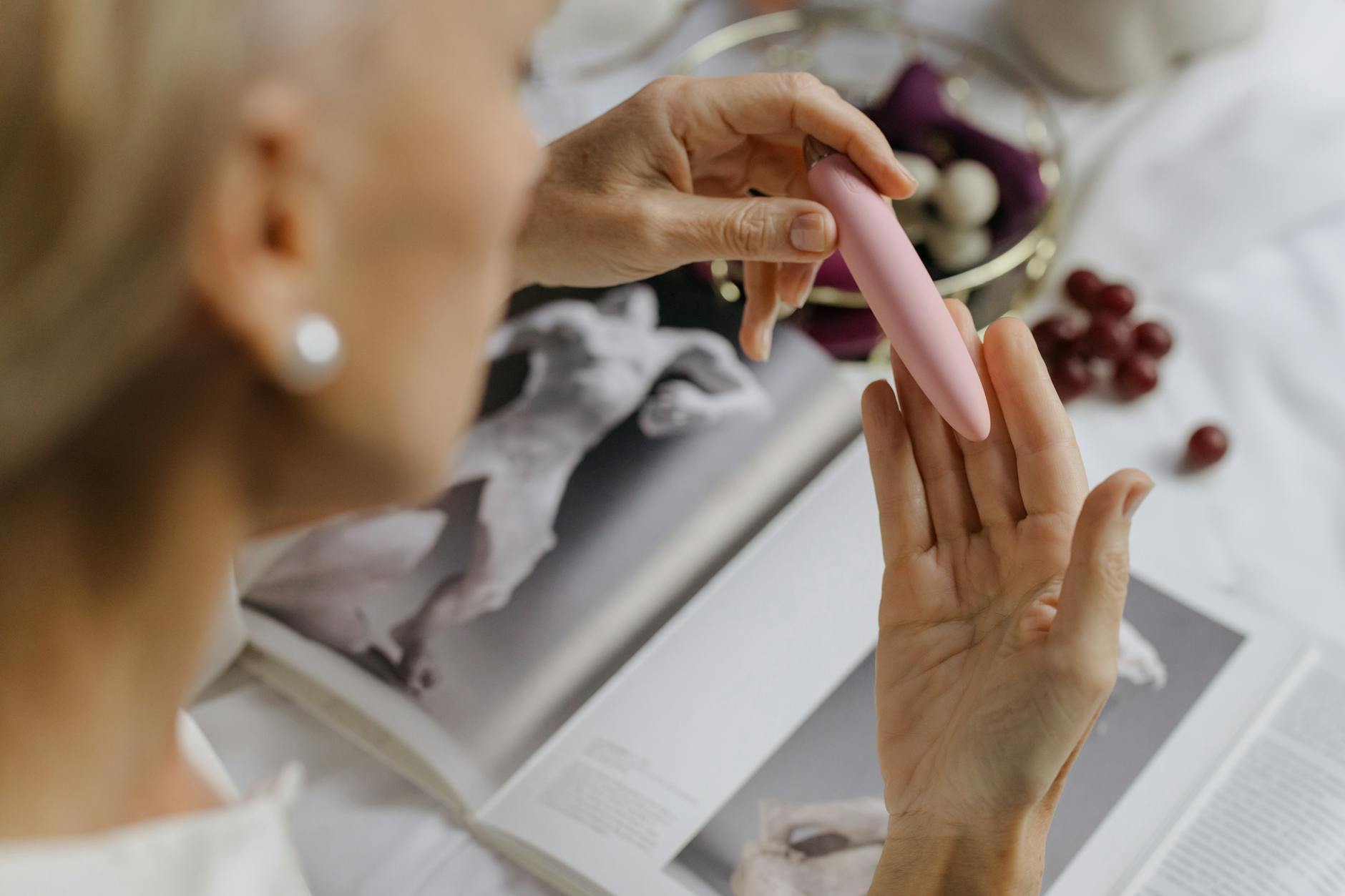 Hands holding pastel-colored silicone toys for intimate wellness