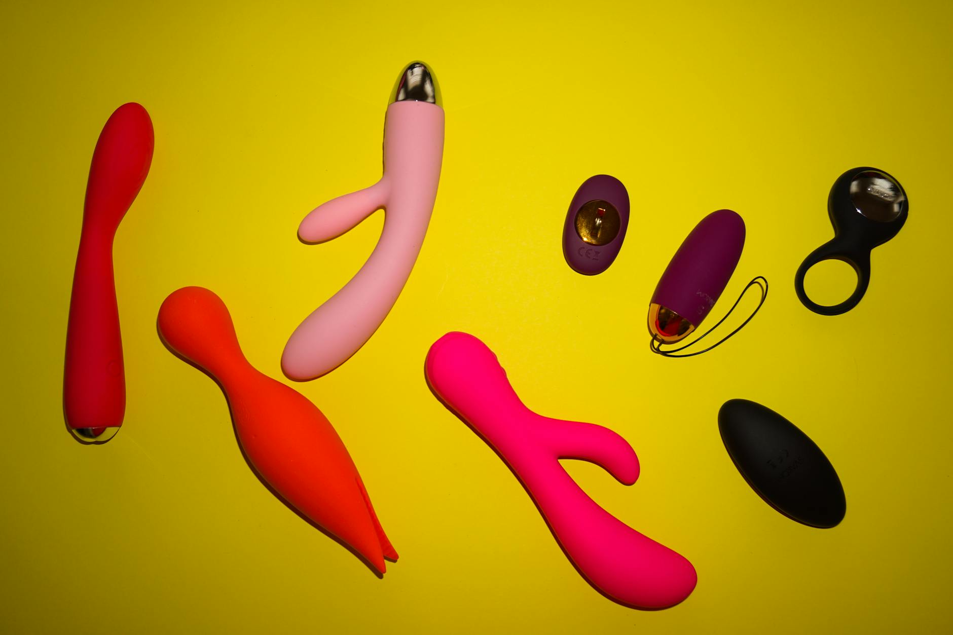 A woman confidently holding a colorful vibrator, representing self-advocacy and pleasure on her own terms